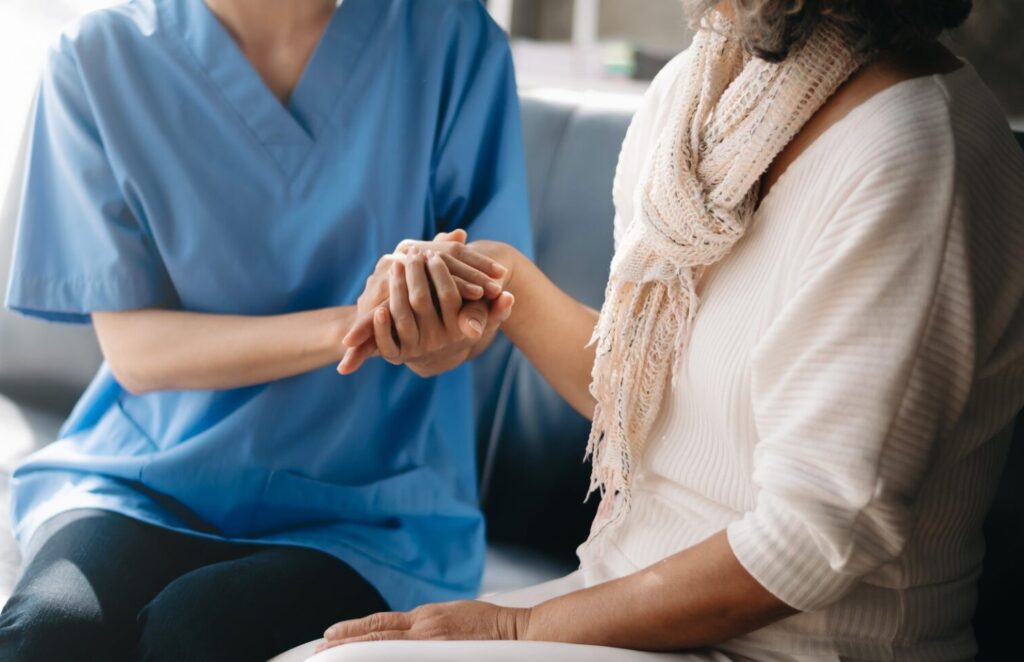 Kind nurse together with elderly woman in the hospital's